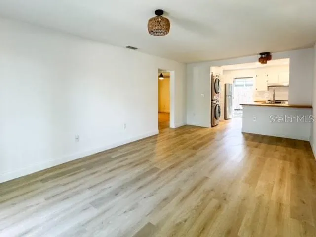 a view of a room with wooden floor and a window