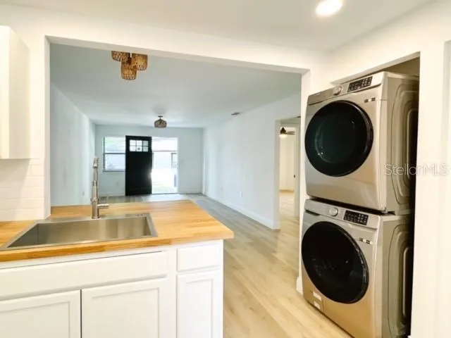 a view of a kitchen with sink washer and dryer