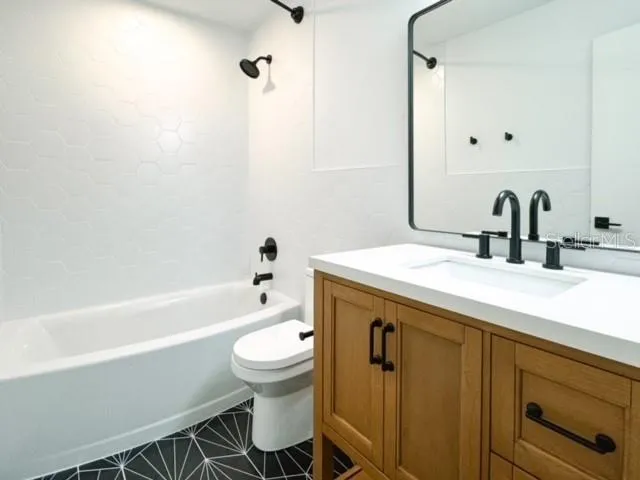 a bathroom with a sink a toilet and a bathtub