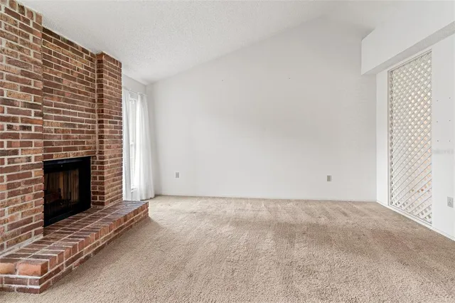 a view of an empty room with a fireplace