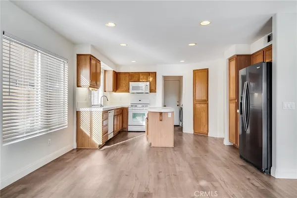 a kitchen with stainless steel appliances a refrigerator and a stove top oven