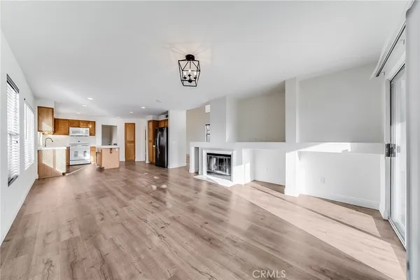 a view of a livingroom with a fireplace and cabinet