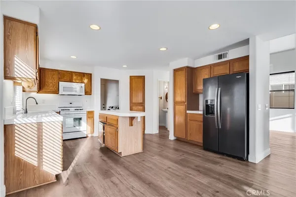 a kitchen with stainless steel appliances a refrigerator and a stove top oven