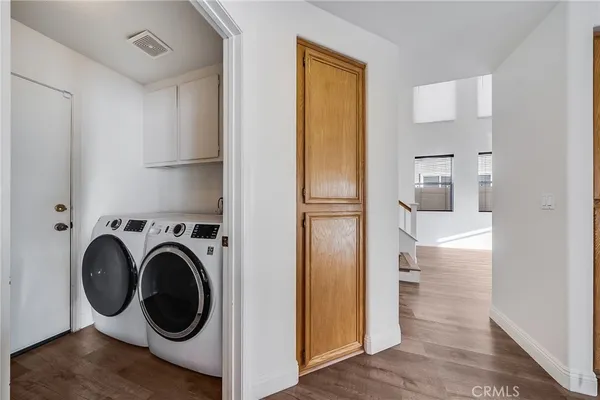 a view of a hallway with washer and dryer