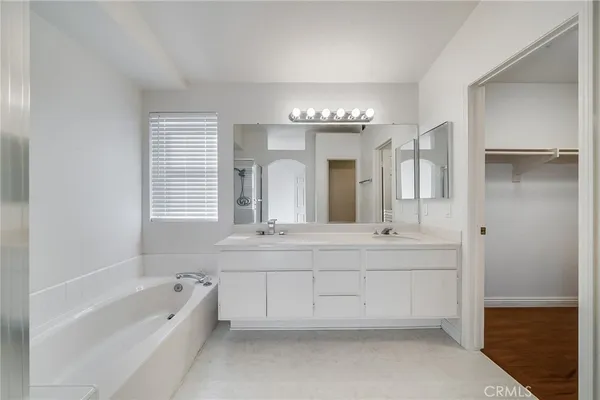 a spacious bathroom with a large tub shower and sink