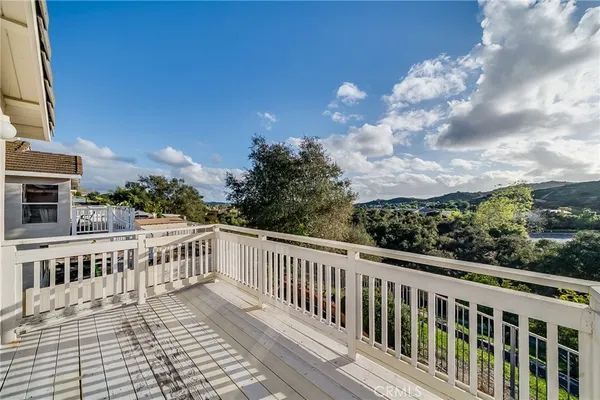 a view of a balcony with wooden fence