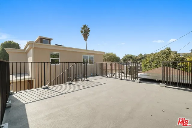 a view of a house with a wooden fence