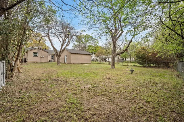 a view of a yard with trees