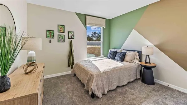 a bedroom with a bed and a potted plant