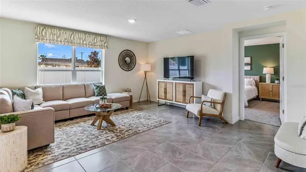 a living room with furniture and a large window