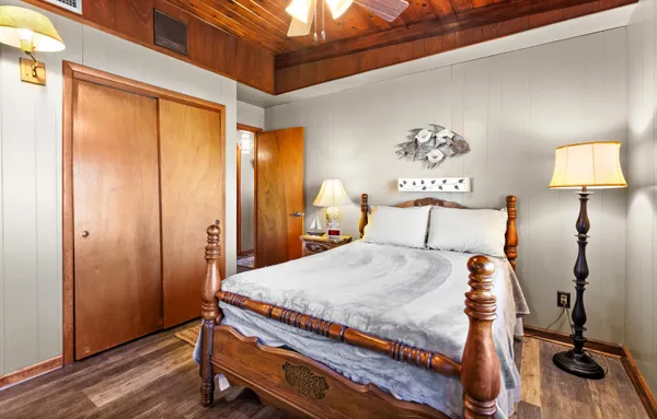 a bedroom with a bed and a chandelier