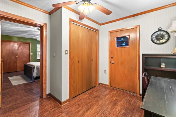 a bedroom with a bed and a flat screen tv on dresser