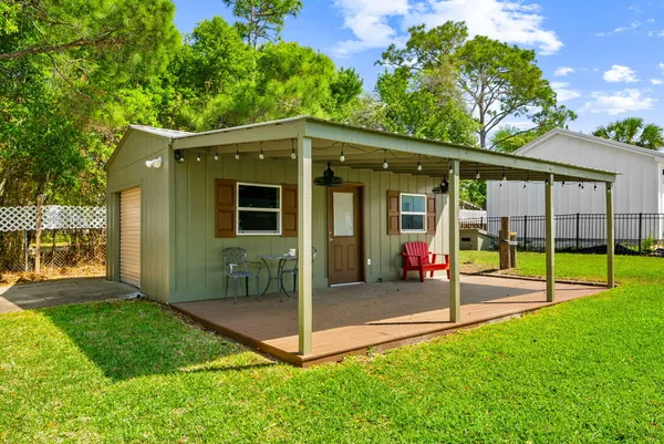 a view of a house with a backyard