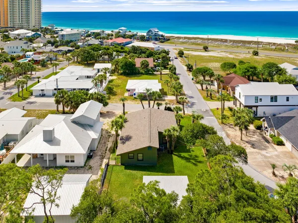 an aerial view of residential houses with outdoor space
