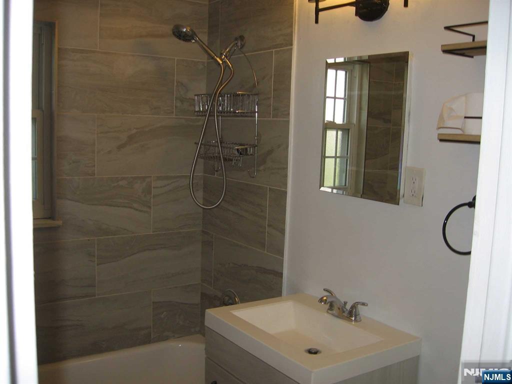 67 Clark Court Rutherford, NJ 07070 - Photo 9 of 12 a bathroom with a sink a toilet and shower