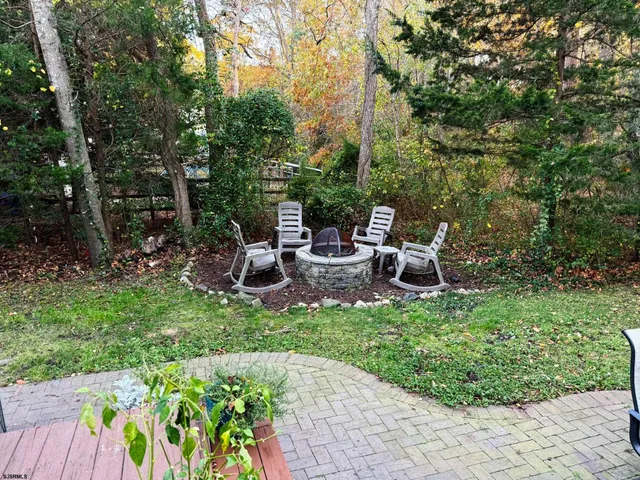 a view of a chair and table in the garden