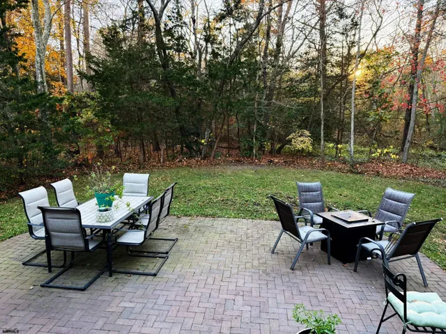 a view of a chairs and a table in a yard