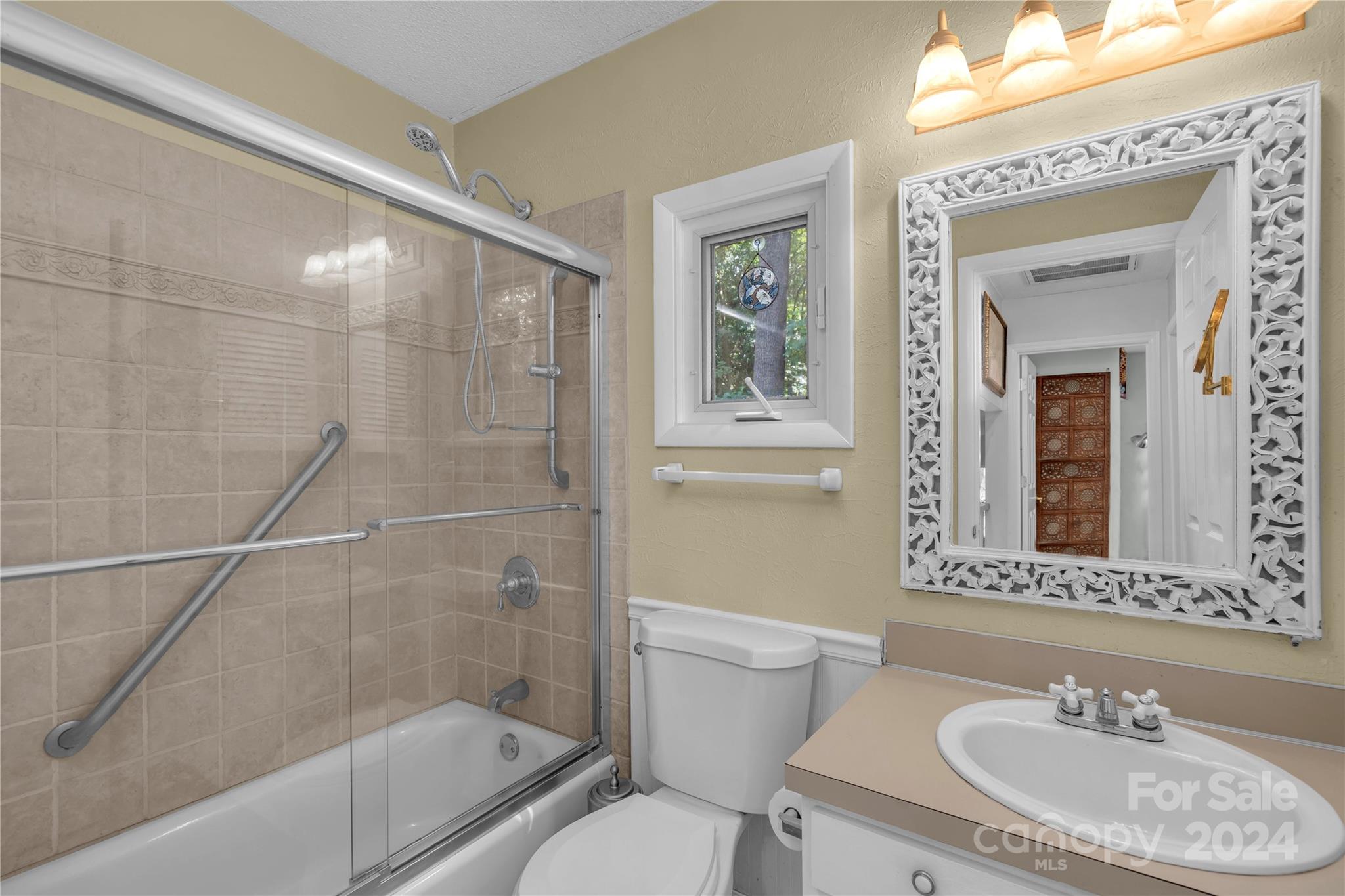 300 Gray Drive Charlotte, NC 28213 - Photo 18 of 40 a bathroom with a sink toilet a mirror and shower