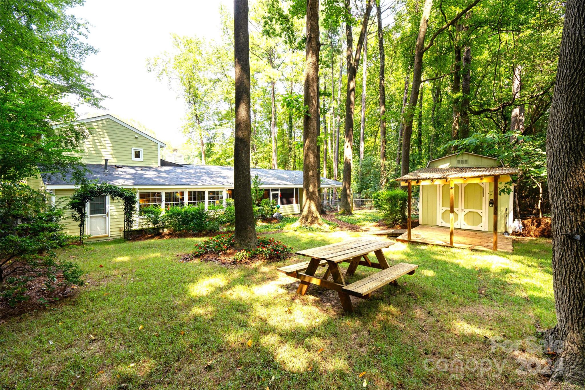 300 Gray Drive Charlotte, NC 28213 - Photo 21 of 40 a view of swimming pool with lawn chairs and large trees