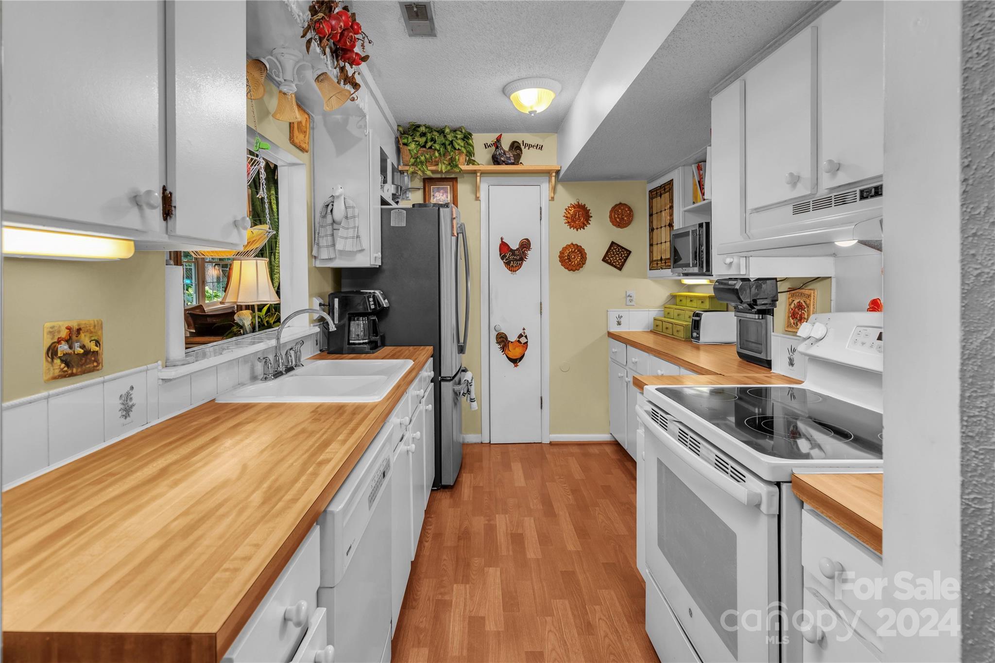 300 Gray Drive Charlotte, NC 28213 - Photo 34 of 40 a kitchen with stainless steel appliances granite countertop a refrigerator a stove a sink and dishwasher with wooden floor