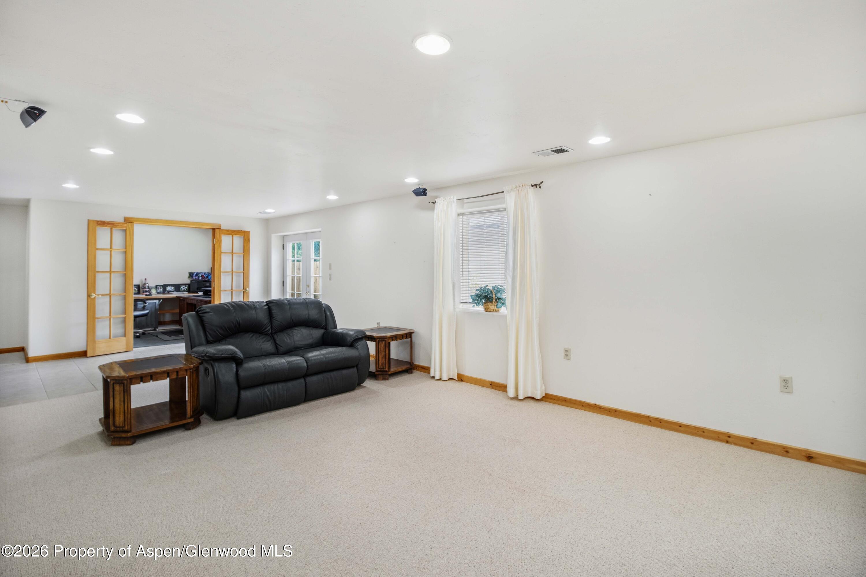 660 Aspen Avenue Rifle, CO 81650 - Photo 21 of 30 a living room with furniture and a refrigerator