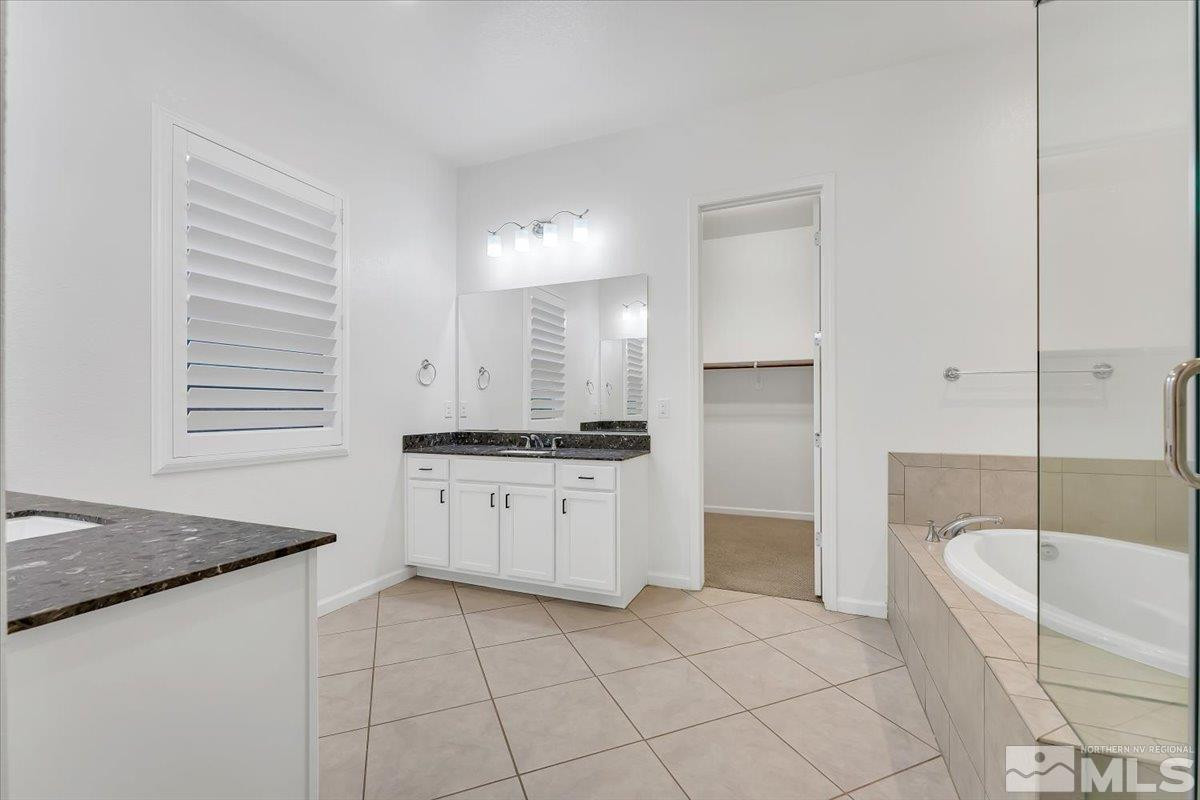9405 Baldacci Road Reno, NV 89521 - Photo 14 of 40 a bathroom with a granite countertop sink mirror and bathtub
