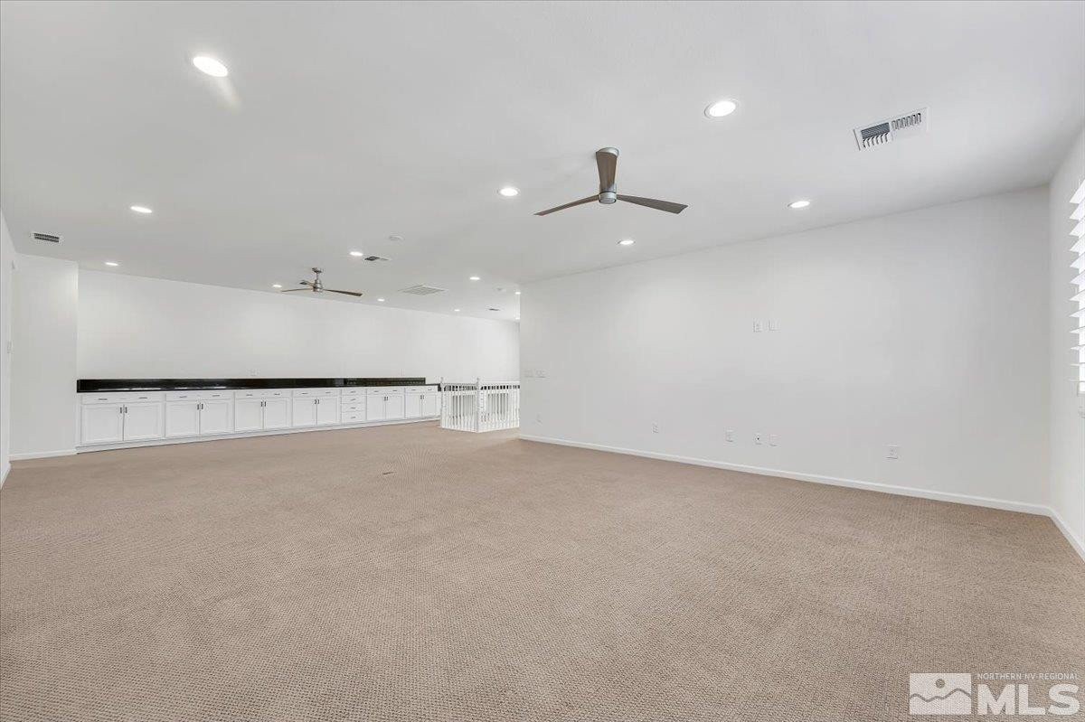 9405 Baldacci Road Reno, NV 89521 - Photo 17 of 40 an empty room with a projector and a ceiling fan