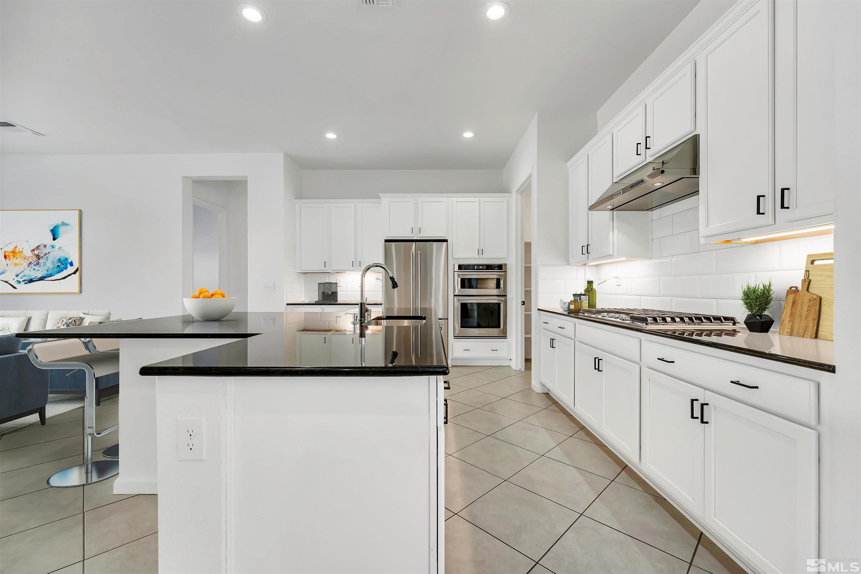 9405 Baldacci Road Reno, NV 89521 - Photo 5 of 40 a kitchen with stainless steel appliances granite countertop a sink and a refrigerator