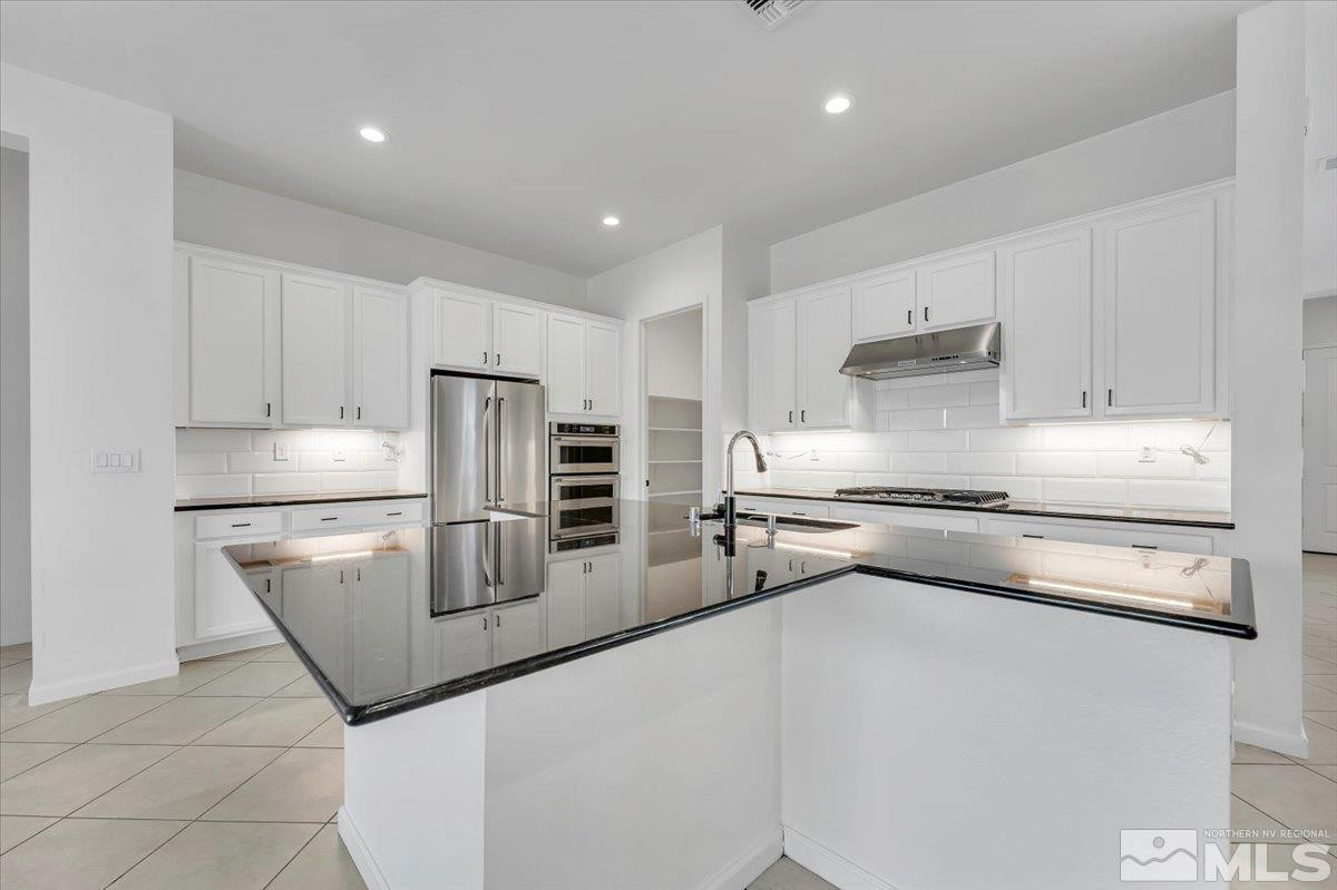 9405 Baldacci Road Reno, NV 89521 - Photo 8 of 40 a kitchen with stainless steel appliances a sink and a stove