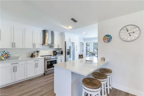 a kitchen with a table and chairs