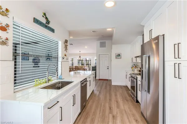 a kitchen with a sink a refrigerator and a stove