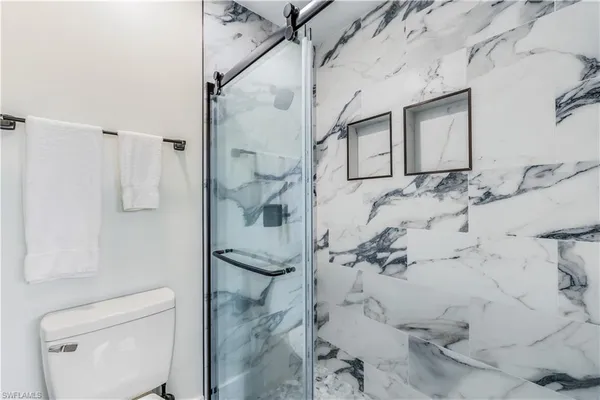 a bathroom with a shower and toilet