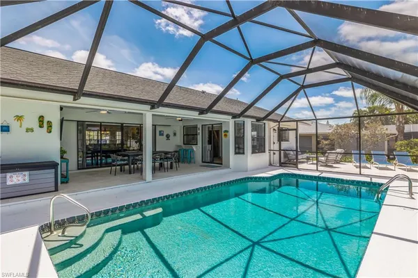a view of a house with a backyard porch and sitting area