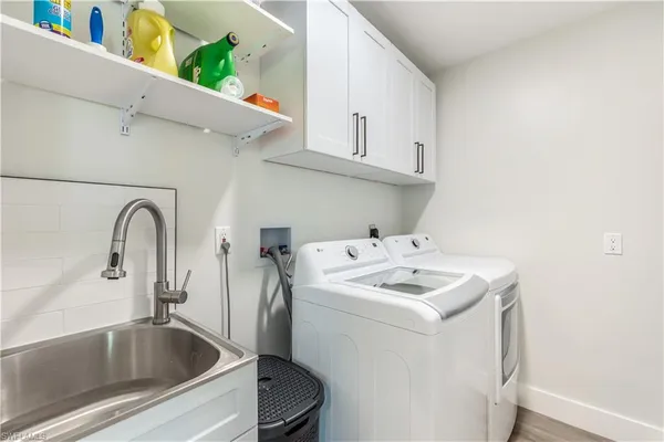 a bathroom with a sink and washing machine