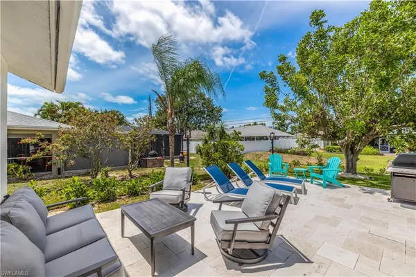 a view of a patio with couches and a table and chairs with garden view
