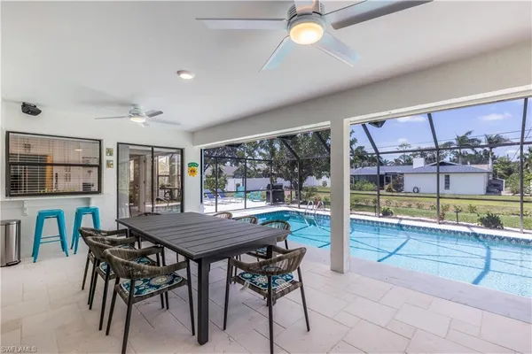 a view of a dining room and livingroom with furniture wooden floor and a rug