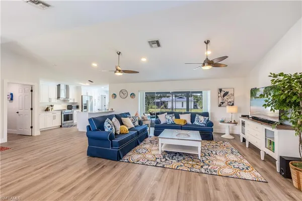 a living room with furniture and a wooden floor