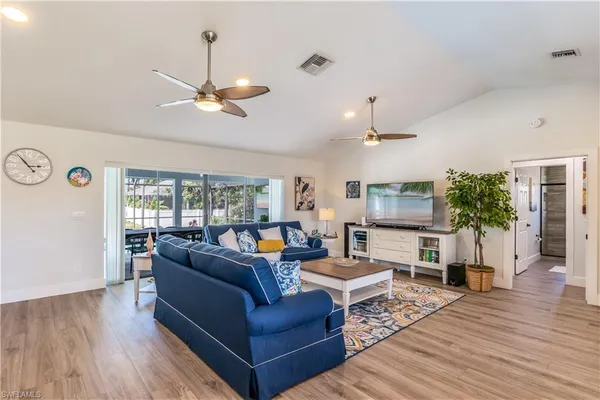 a living room with furniture a fireplace and a flat screen tv