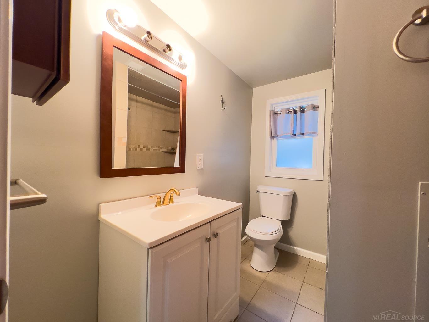 1123 Radov Road Gladwin, MI 48624 - Photo 11 of 29 3 fixture bath with a linen closet behind the entry door.