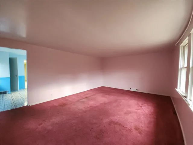 an empty room with windows and yard