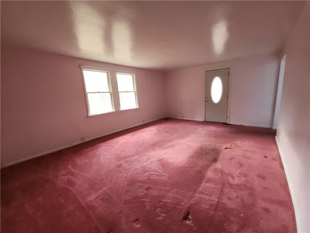 a spacious bedroom with a bed and window