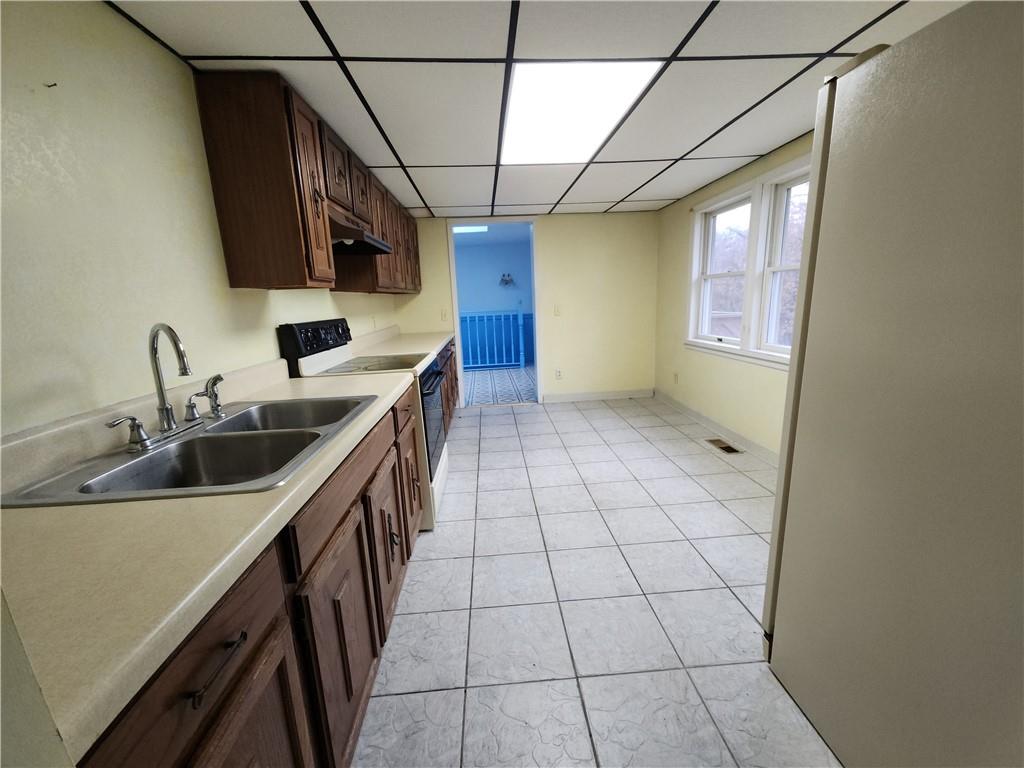 31 Wheatley Road Charleroi, PA 15022 - Photo 5 of 48 a kitchen with a sink a stove and a refrigerator
