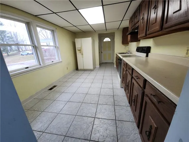 a kitchen with stainless steel appliances cabinets and a window