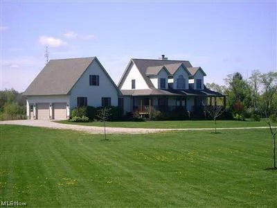View of front of home featuring a garage and a front lawn
