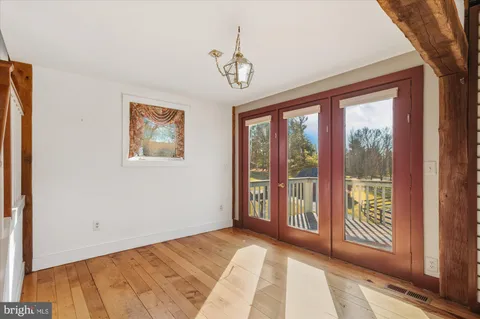 a view of a room with wooden floor and a window