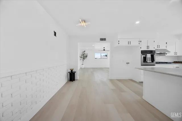 a view of a kitchen with wooden floor