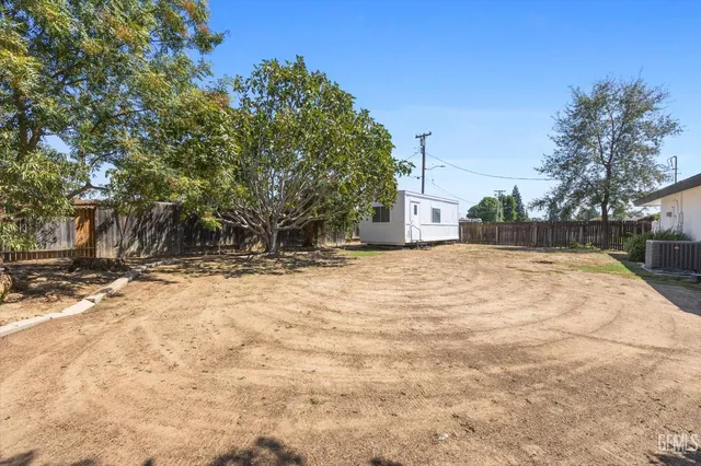 a view of large tree with yard