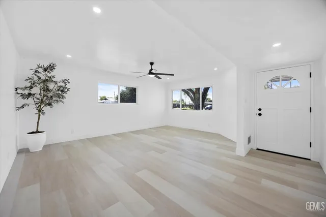 a view of empty room with wooden floor and potted plant