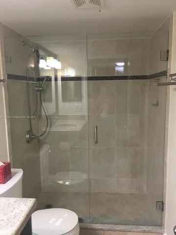 a bathroom with a shower and toilet