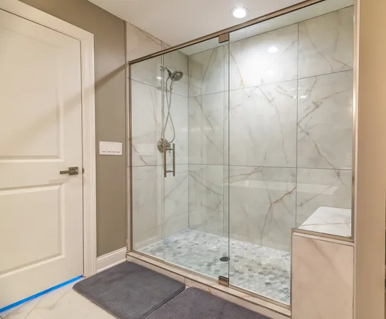 a bathroom with a glass shower door